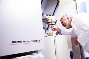 Scientist using equipment for hazardous chemistry at Radiofilum