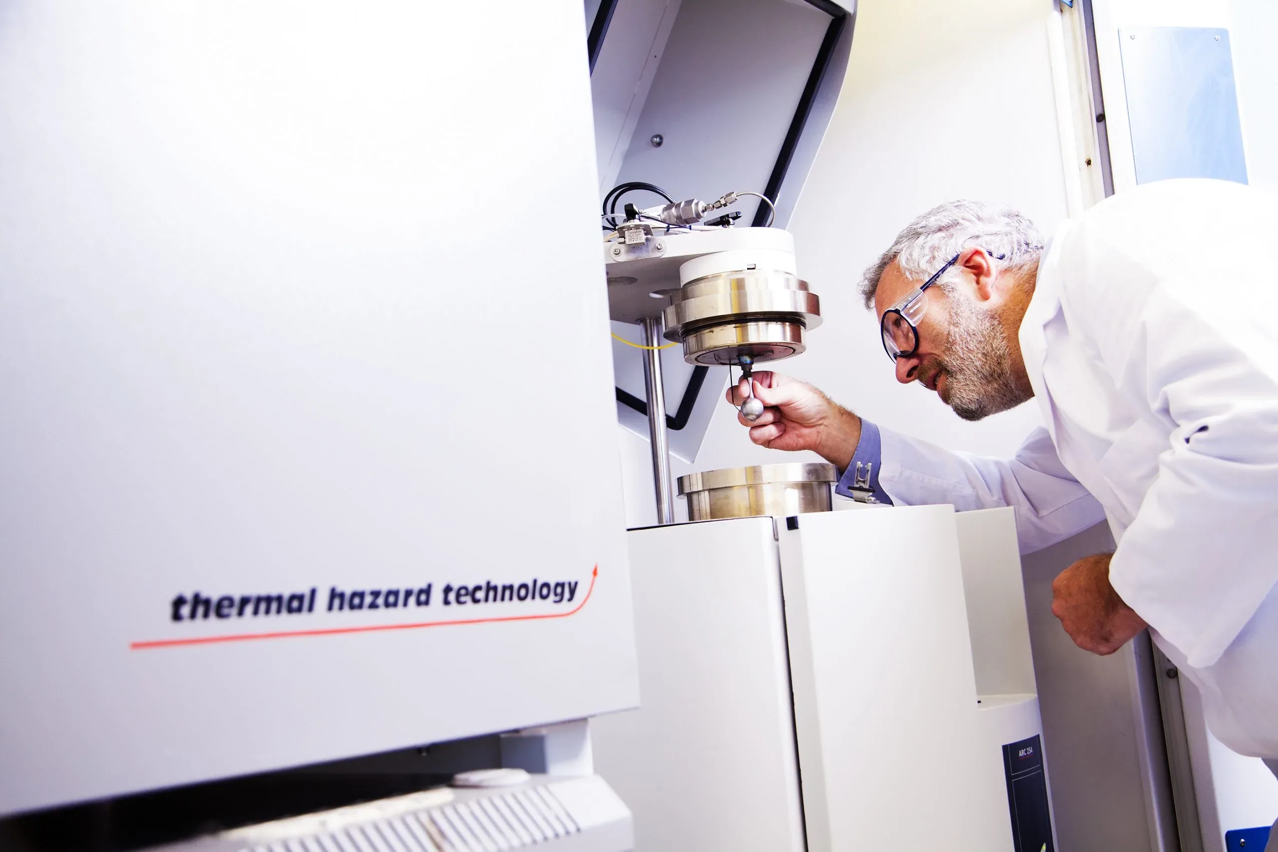 Scientist using equipment for hazardous chemistry at Radiofilum