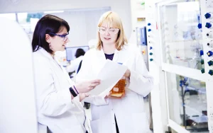 Scientists in the lab discussing a Diazomethane project
