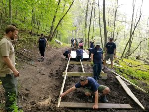 Employees at Germantown volunteering within their community, building a bridge at Pike Lake